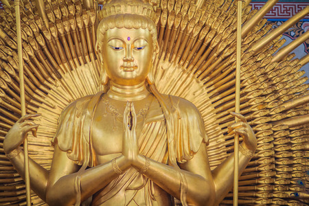 Golden statue of Guan Yin with 1000 hands. Guanyin or Guan Yin is an East Asian bodhisattva associated with compassion as venerated by Mahayana Buddhists and known as the "Goddess of Mercy" in Englishの写真素材