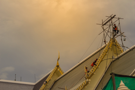 Chachoengsao, Thailand - May 12, 2017: Unidenitified workers during repair roof of the church in Wat Sothonwararam, a famous public temple in Chachoengsao Province, Thailand.のeditorial素材