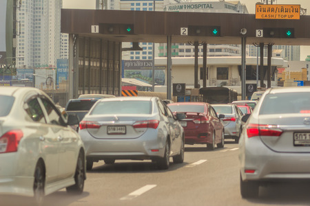 Bangkok, Thailand - May 23, 2017: The cars were queued on express way, tollway or motorway gate for pay toll fee.のeditorial素材