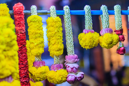 Colorful marigold flower garlands for hindu religious ceremony. Garland of indians for worship goddess in the florist shop nearby Sri Maha Mariamman Temple, Silom, Bangkok, Thailand.の写真素材