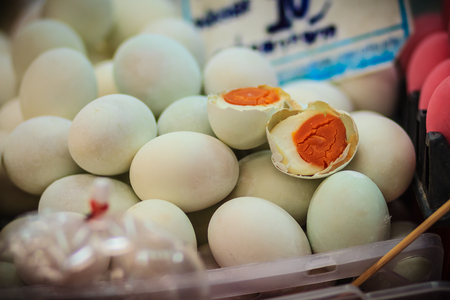 Salted duck eggs for sale in the fresh market. The preservation of duck eggs with salt. Yolk of salted eggs.の写真素材