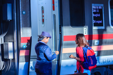 Bangkok, Thailand - April 23, 2017: Uniformed train hostess is welcoming and serving passengers in Hua Lamphong railway station for the express train from Bangkok to Chiang Mai destination.のeditorial素材