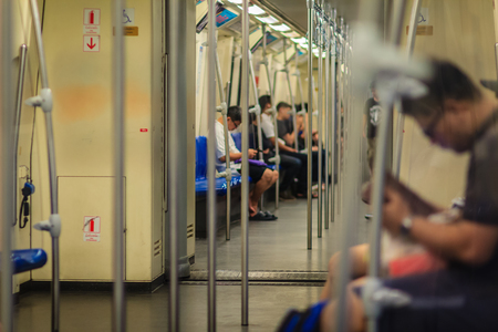 Bangkok, Thailand - April 23, 2017: Blurry passengers using smart phone in MRT (Metropolitan Rapid Transit) subway, the public transportation in Bangkok, Thailand.のeditorial素材