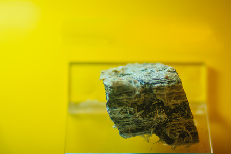 Asbestos rock specimen from mining and quarrying industries. Asbestos is a set of six naturally occurring silicate minerals, which all have in common their eponymous asbestiform habit.の写真素材
