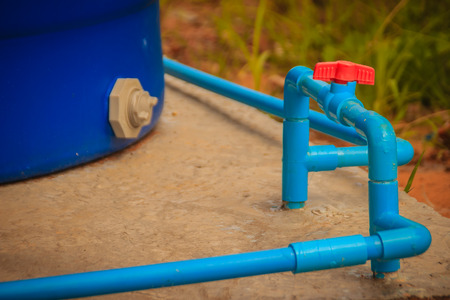 Red knob of PVC ball valve on the PVC pipe line in plumbing system for control the water to storage tank.の写真素材