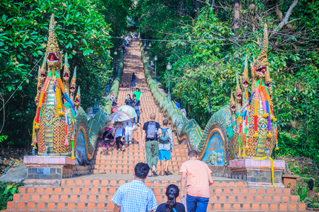 Chiang Mai, Thailand - May 3, 2017: Tourist are walking up the naga stairs to worship the golden chedi at Wat Phra That Doi Suthep, the famous temple and became the landmark of Chiang Mai, Thailand.のeditorial素材