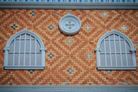 Abstract art of balconies which decorated in circle shape above arch window on brick wall background.の写真素材