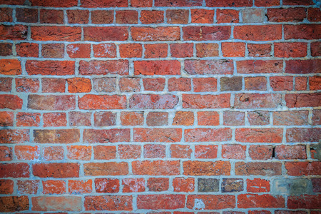 Abstract red brick old wall texture background. Ruins uneven crumbling red brick wall background...