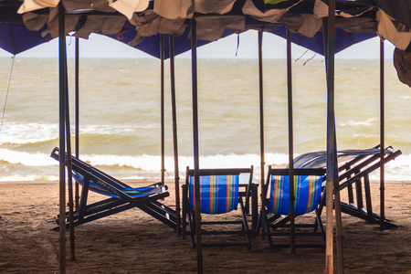 Canvas umbrellas and chairs on the beach at Chao Samran beach, Phetchaburi, Thailand. のeditorial素材