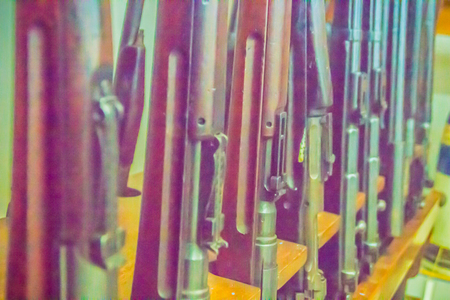 Old military rifle in the public museum. A rifle is a firearm designed to be fired from the shoulder, with a barrel that has a helical groove or pattern of grooves cut into the barrel walls. の写真素材