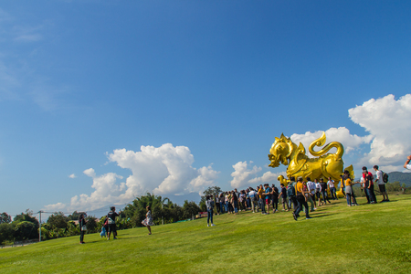 Chiang Rai, Thailand - November 19, 2017: Golden lion statue logo under blue sky and white clouds background at Boonrod farm or singha park, the famous agriculture tourist attraction in Chiang Rai.のeditorial素材
