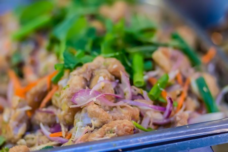 Fried chicken with variety of vegetables for serve in the buffet party in the restaurant. Hot and spicy chicken dish with tomatoes, carrots, onions and lots of red hot chilli.の写真素材
