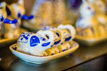 Vintage Thai's style handmade porcelain tea cups set. Beautiful traditional Thai five-colored porcelain ceramic tea cup set. Benjarong Porcelain tea cups for sale in the flea market, Thailand.の写真素材