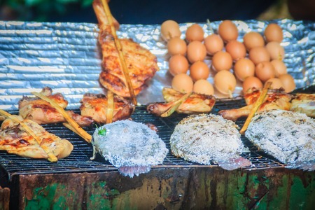 Salt coated tilapia fish that grilled on charcoal stove. Grilled chicken in bamboo stick and grilled...