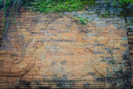 Old ruin brick wall covered with green moss and small grass. Old khmer sanctuary brick wall...