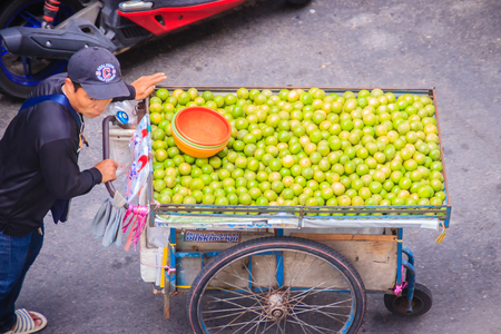 Bangkok, Thailand - August 21, 2017: Unidentified street hawker pushing a cart on a street for selling lemon around Bangkok, Thailand.のeditorial素材