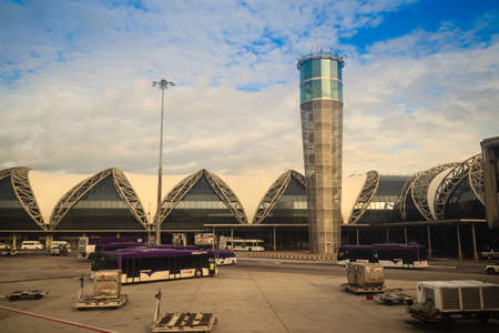 Bangkok, Thailand - August 9, 2017: Airplane control tower and the terminal building with blue sky background at Suvarnabhumi International Airport, Thailand.のeditorial素材