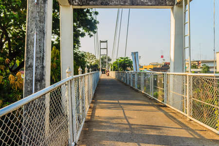 Suspension bridge spanning across Nan river to Phichit railway station in Muang district of Phichit...