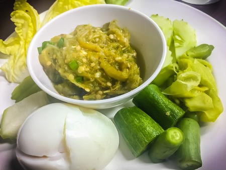 Green chili dip or Nam Prik Num in Thai is green chili paste that eat with boiled egg and boiled vegetables.の写真素材