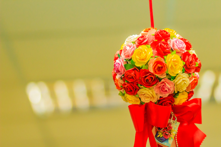 Red flower bouquet is hanging on the ceiling at the office to decoration prepare for Christmas and new year party cerebration.の写真素材