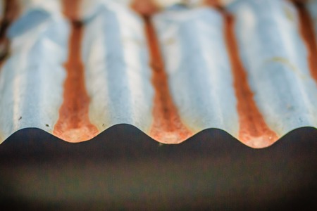 Background texture of the roof of old zinc sheet, metal roof sheet with rusty texture, rusty metal...