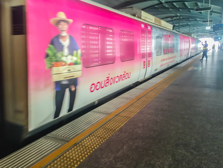 Bangkok, Thailand - January 12, 2018: Passengers are waiting the arrival of the airport rail link sky train. People wait in an orderly line behind the yellow arrows pointing towards the tracks.のeditorial素材
