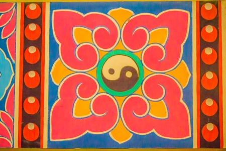 Golden symbol of Yin - Yang on the ceiling of Chinese temple. Yin and Yang is that all things exist as inseparable and contradictory opposites, for example, female-male, dark-light and old-young.のeditorial素材