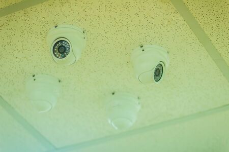CCTV camera system security inside office. Surveillance camera installed on ceiling to monitor for safety protection.の写真素材