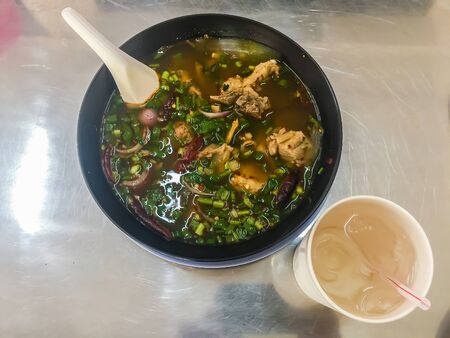 Hot and spicy soup with pork ribs, or Tom Saeb Kraduk Moo, Thai style food. Tom yum pork cartilage...