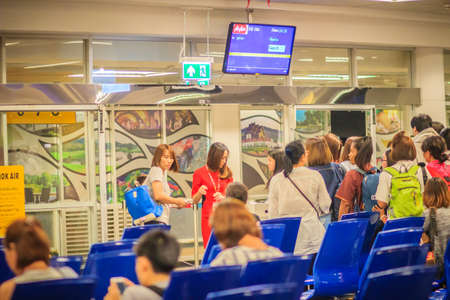 Chiang Mai, Thailand - May 3, 2017: Flight attendant is checking passports and boarding cards of the...