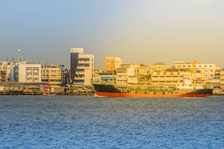 Massive container ship for import export and business logistic. Big cargo ship is leaving from Bangkok Port Authority of Thailand or Klong Toey port along Chao Phraya river in Bangkok,Thailand.の写真素材