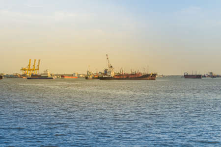 Massive container ship for import export and business logistic. Big cargo ship is leaving from Bangkok Port Authority of Thailand or Klong Toey port along Chao Phraya river in Bangkok,Thailand.の写真素材