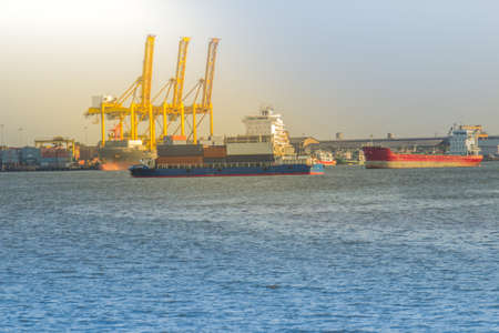 Massive container ship for import export and business logistic. Big cargo ship is leaving from Bangkok Port Authority of Thailand or Klong Toey port along Chao Phraya river in Bangkok,Thailand.の写真素材