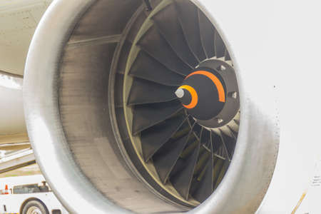 Closeup huge aircraft jet engine while airplane parked at the airport.