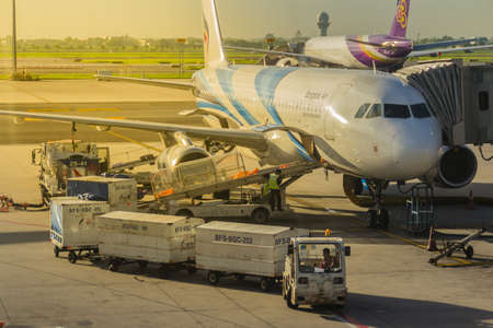 Bangkok, Thailand - June 13, 2017: Airplane staffs of Bangkok Airways (a regional airline based in Bangkok) is uploading baggage before taking off at Suvarnabhumi Airport.のeditorial素材