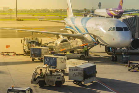 Bangkok, Thailand - June 13, 2017: Airplane staffs of Bangkok Airways (a regional airline based in Bangkok) is uploading baggage before taking off at Suvarnabhumi Airport.のeditorial素材