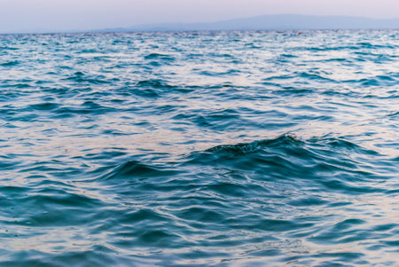 Surface texture of the Aegean sea. Small sea waves.