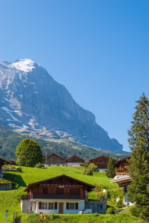 Alpine Chalet on the background of Eiger peak. Grindelwald Switzerland Europeの写真素材