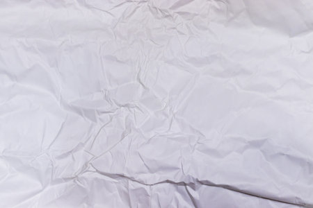 Background or pattern of wrinkled white rectangular paper with soft texture.の写真素材
