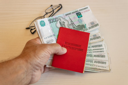 pension id and money on the table. The inscription on the certificate - 'pension certificate'の写真素材