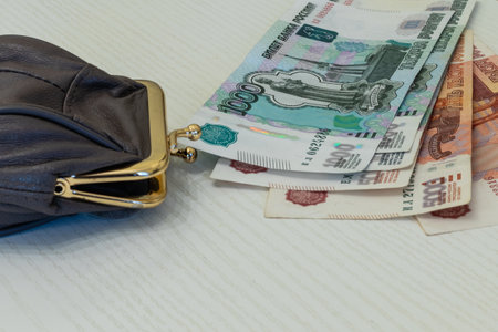 wallet with coins and banknotes in thousand and five thousand rubles on the table surface.の写真素材