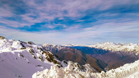 Winter mountain landscape with a view of the Caucasus range covered with snow on a Sunny day. Krasnaya Polyana, Sochi Russiaの写真素材