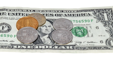 Several coins of 1 ruble against the background of 1 us dollar bill, close upの写真素材