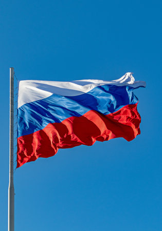 Russian flag flying on a flagpole in a strong wind. symbol of patriotism. Tula. Russiaの写真素材