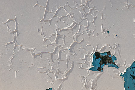 crackling texture of white oil paint on the glass surface. cracks cracks the abstract background. Vintage pattern of creases, spots for design.の写真素材