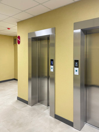 Lobby of a new residential building featuring sleek elevators and modern interior design
