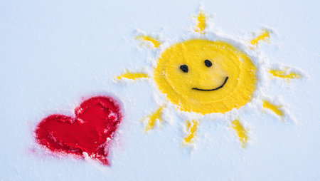 Smiling sun and heart on snowy background. generated by aiの素材