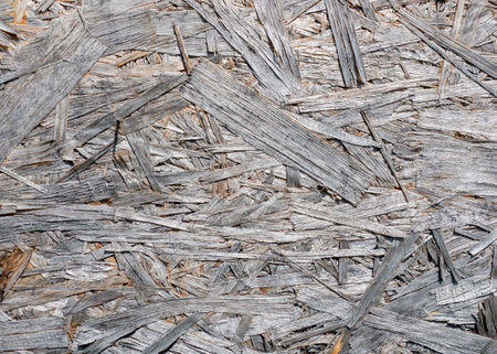 Old OSB board texture with layered wood strands for construction or design projectsの写真素材