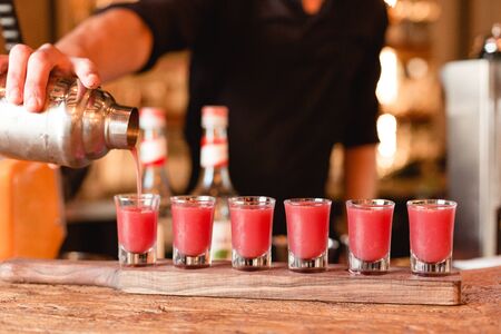 light and invigorating pink drink in shotsの写真素材