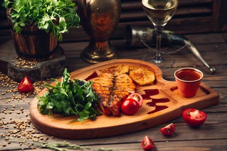fried salmon with potatoes and vegetablesの写真素材